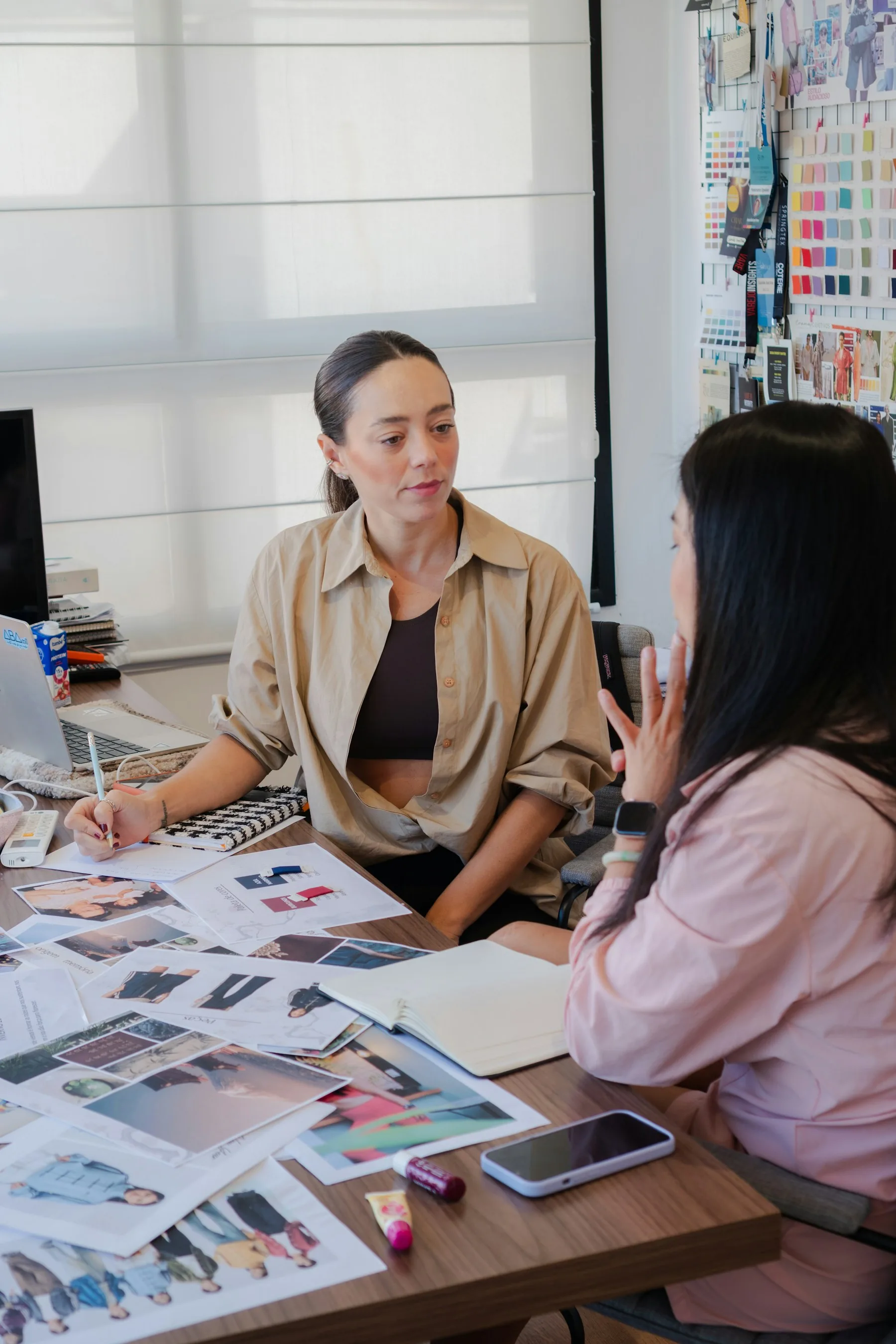 Two designers collaborating over visual references