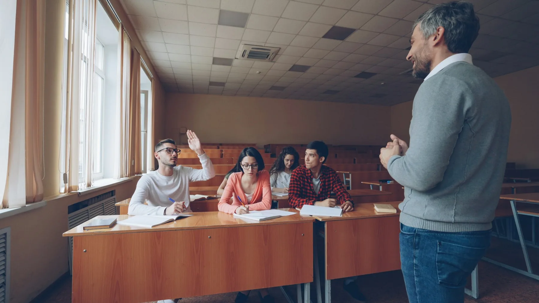An educator discussing ideas with adult learners